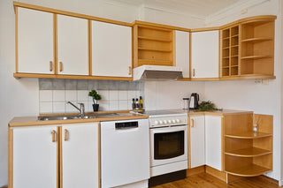 A kitchen with white appliances and wooden cabinets