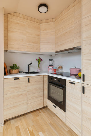 A kitchen with wooden cabinets and a black stove top oven